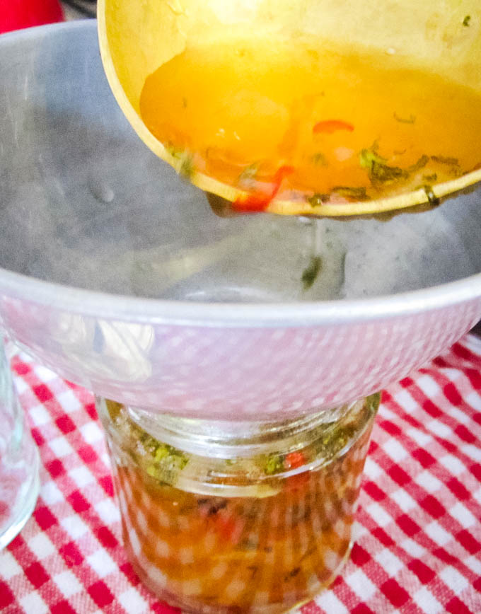 pouring jelly into jars