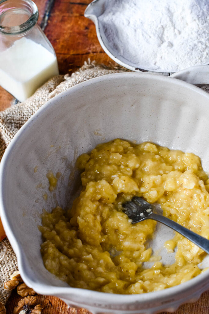mashing bananas in a bowl