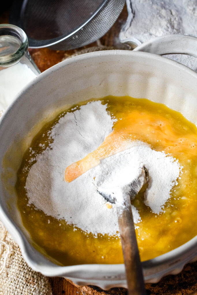 adding egg, flour and milk to the mixing bowl