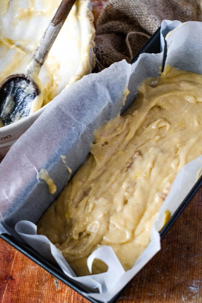 banana bread batter in lined loaf tin