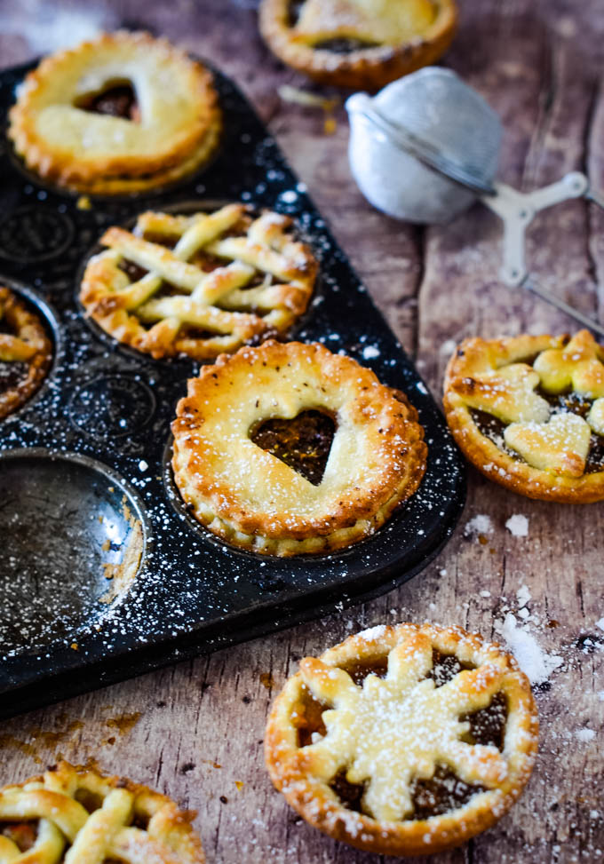 pies with icing sugar sifter in background