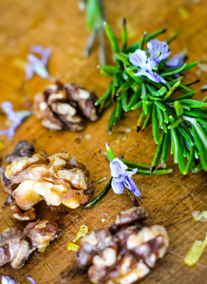rosemary and walnuts on chopping board