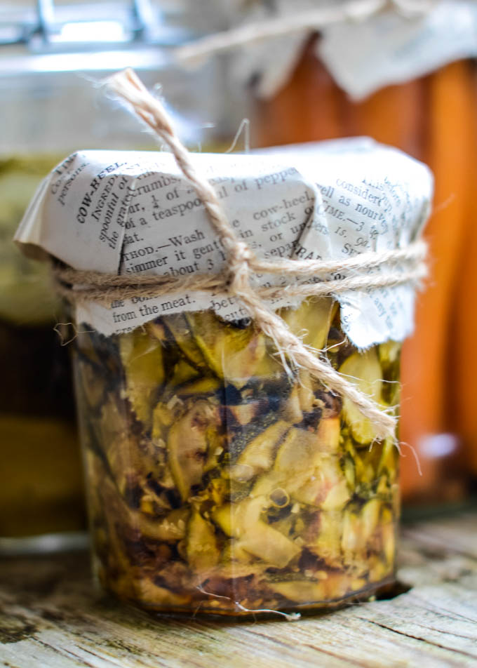grilled courgettes in oil in jar with paper on lid