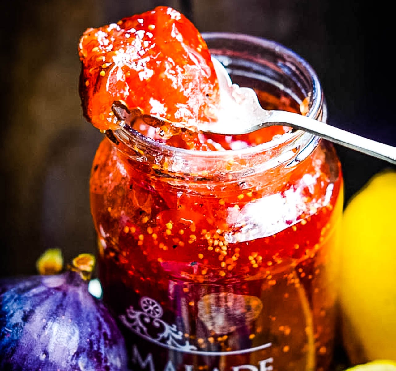close up of jar of fig and lemon marmalade with spoon