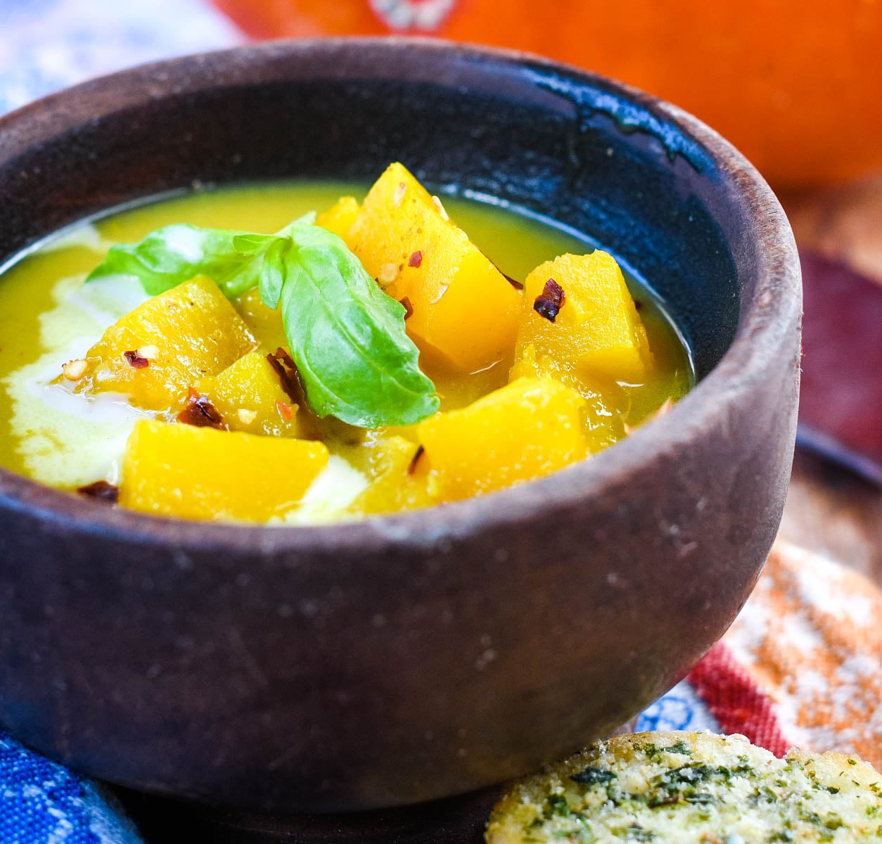 wooden bowl of pumpkin and coconut soup