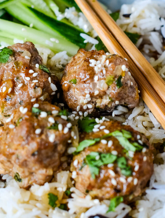 sweet and sour pork meatballs with marmalade glaze with chopsticks in bowl
