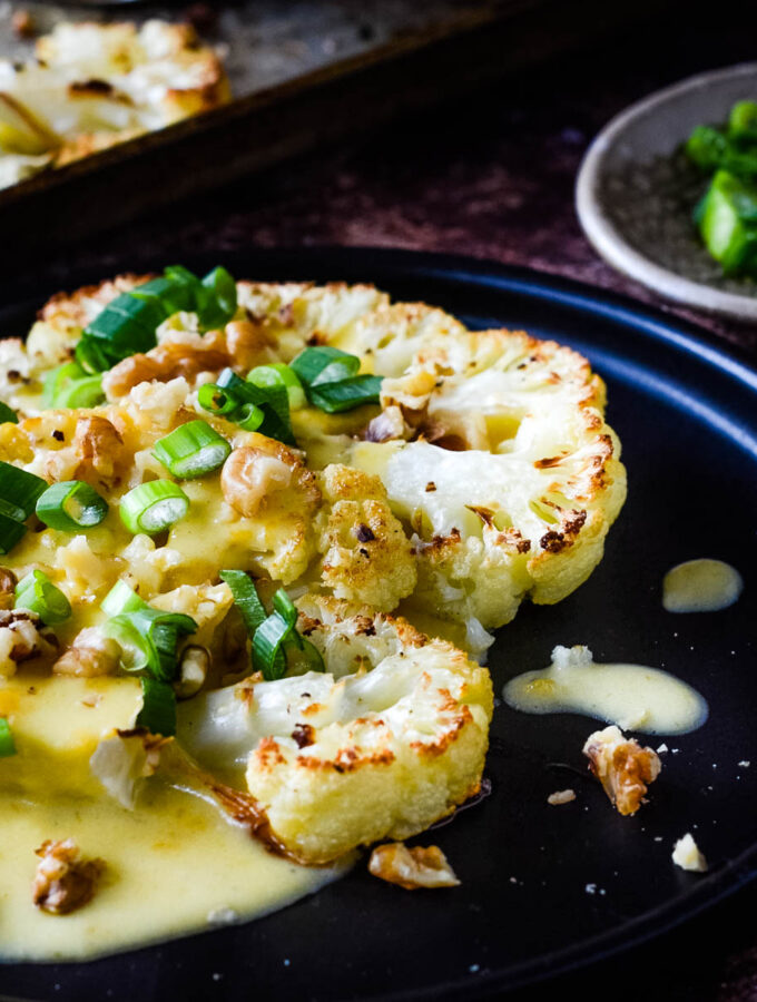 roasted cauliflower steaks with cheese sauce xclose up