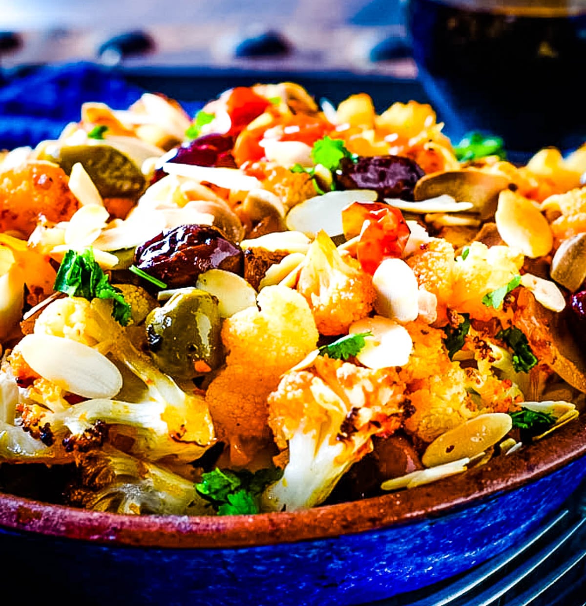 roasted Mediterranean cauliflower traybake in blue bowl