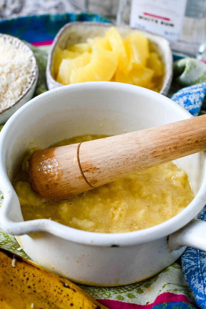 mashing the bananas in mortar with pestle