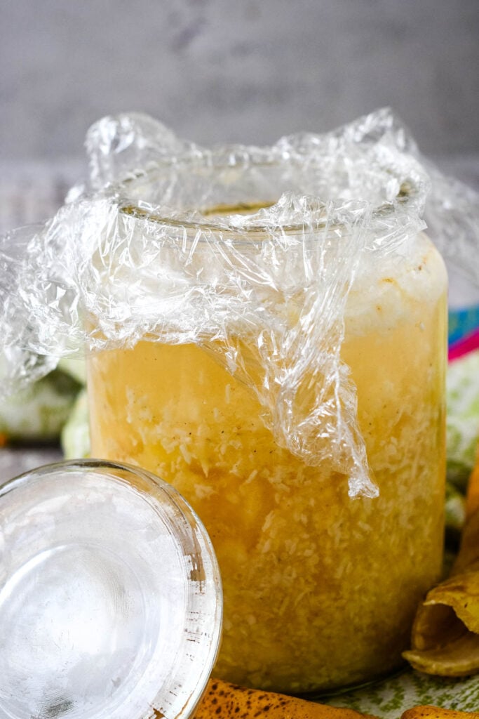 putting clingfilm on top of liqueur before adding the lid