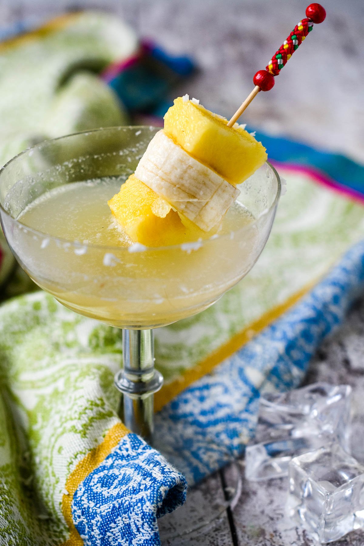 Tropical liqueur in cocktail glass with fruit