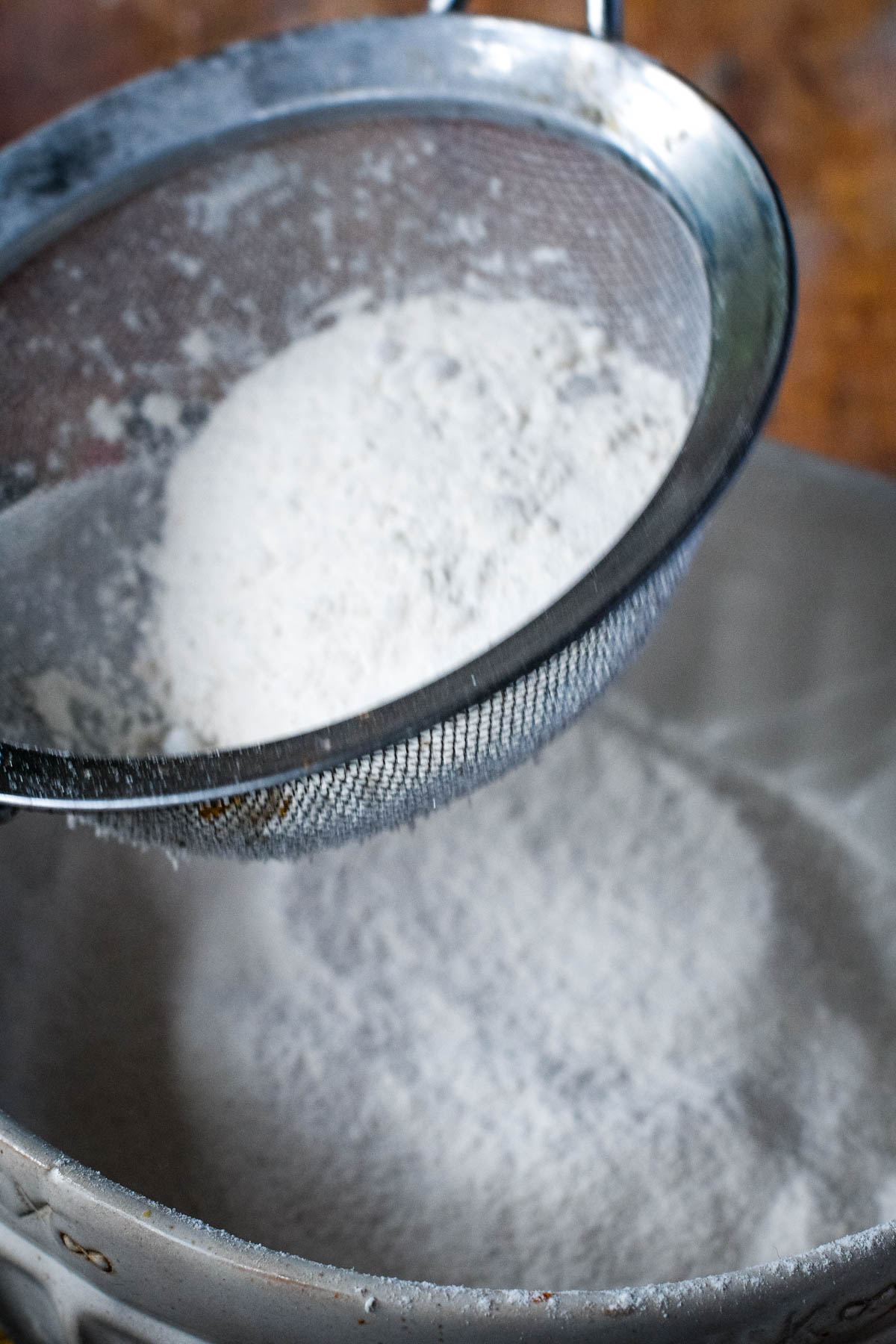 sieving flour, sugar and salt into bowl