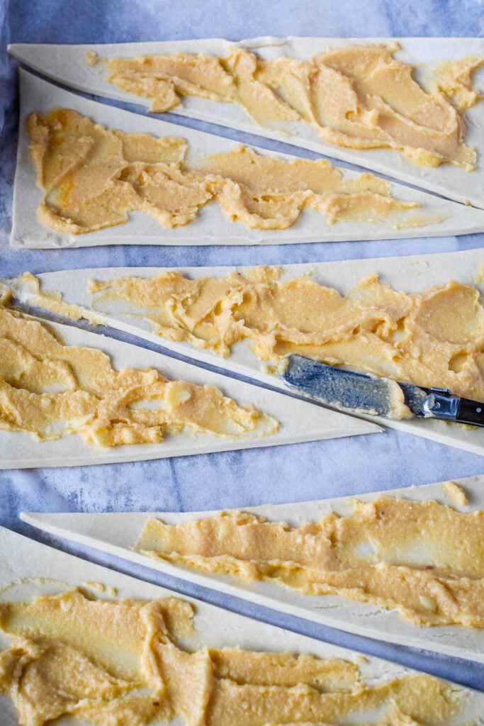 spreading the frangipane paste on to the pastry triangles