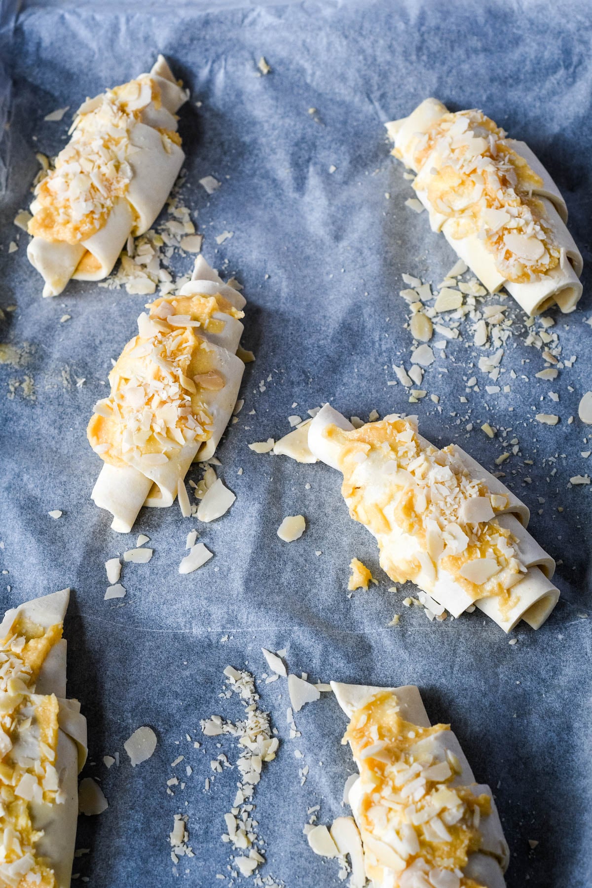 rolled up almond croissants ready to bake in the oven