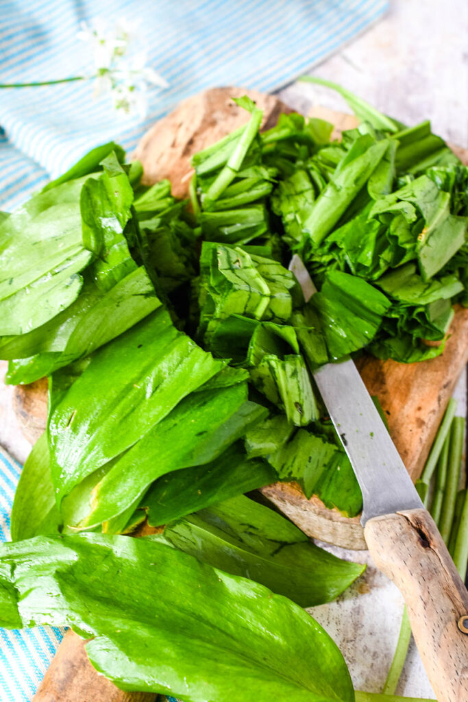 roughly chopping the wild garlic on wooden board