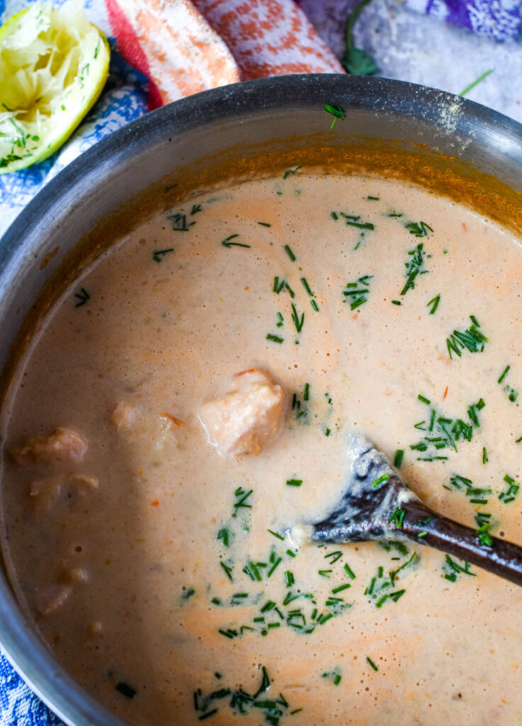 adding the fresh herbs to the soup