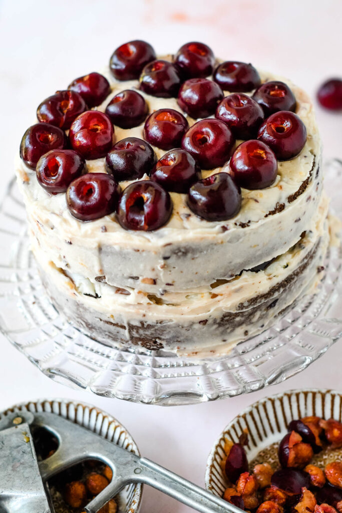 cake covered in frosting with cherries on top