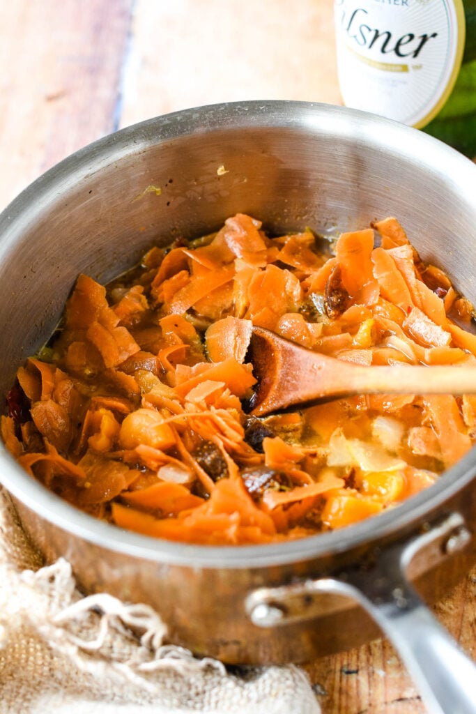 all ingredients in pan with wooden spoon
