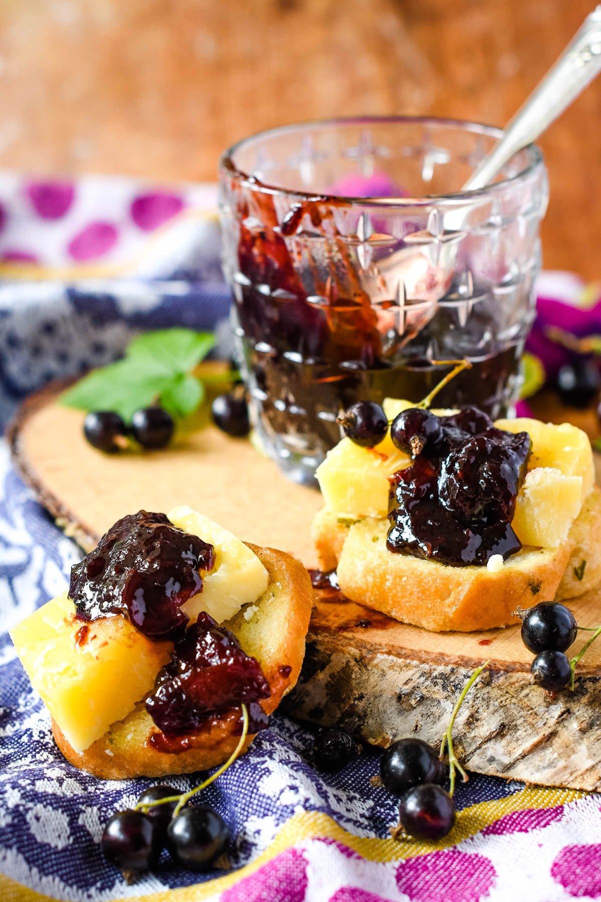 jar of chutney with bread and cheese topped with chutney in front