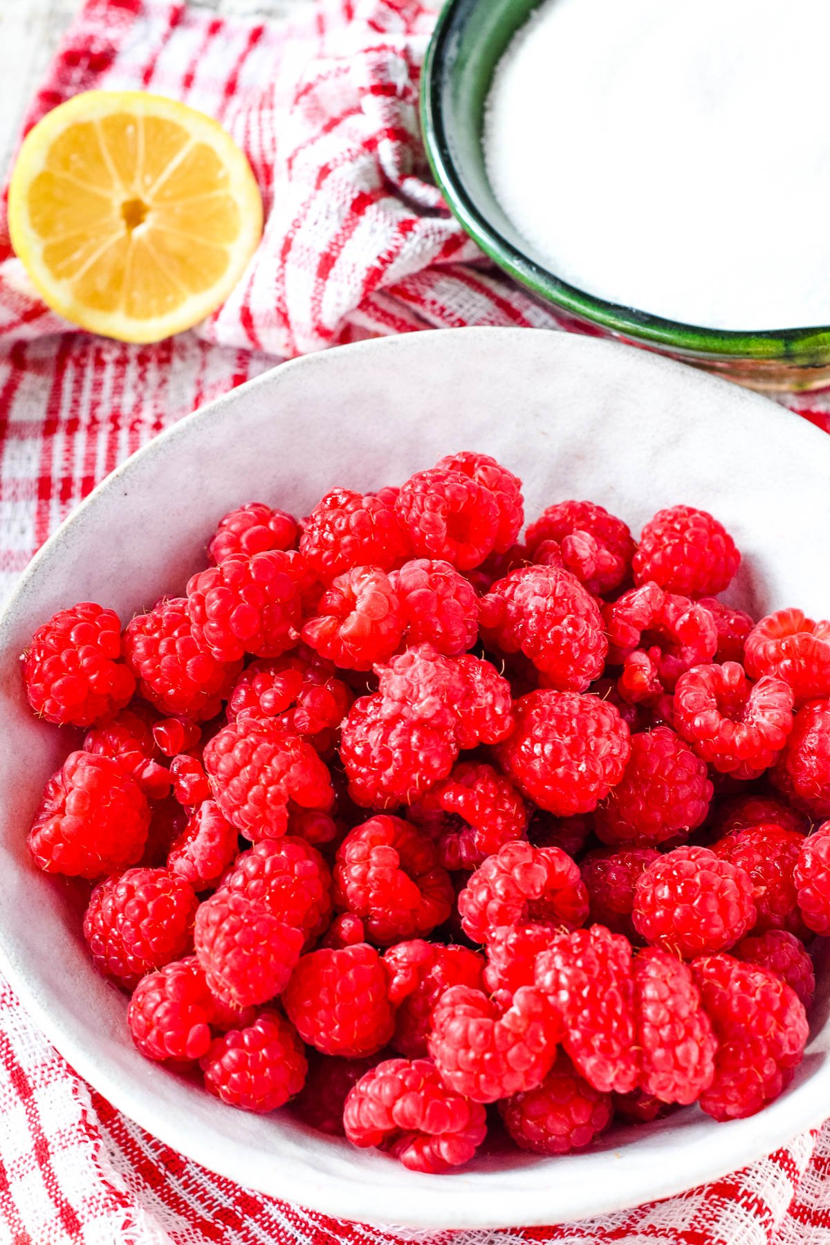 ingredients - raspberries, sugar and half a lemon