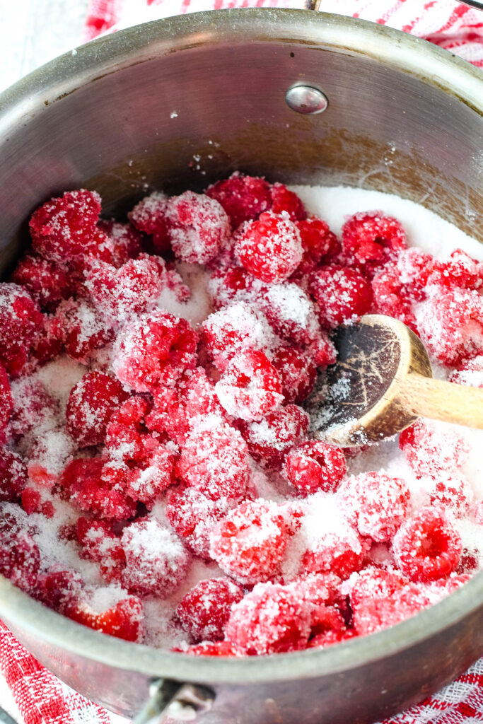 raspberries in a bowl with sugar