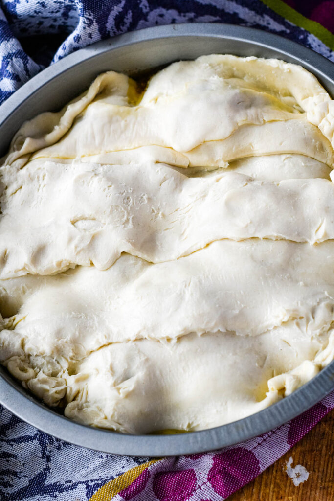 baking tin covered with the pastry ready to go in oven