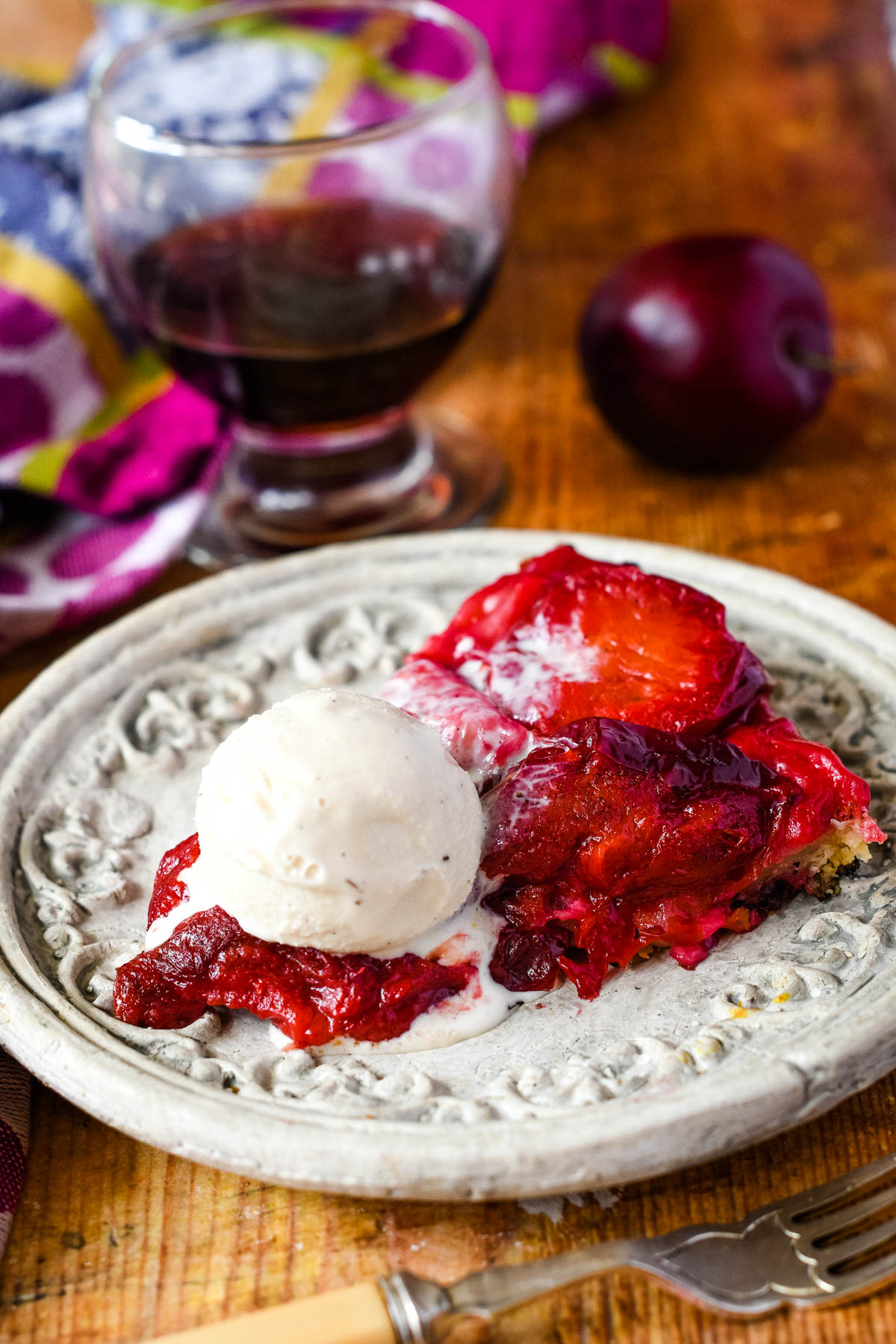 slice of plum tarte tatin with ice cream on top