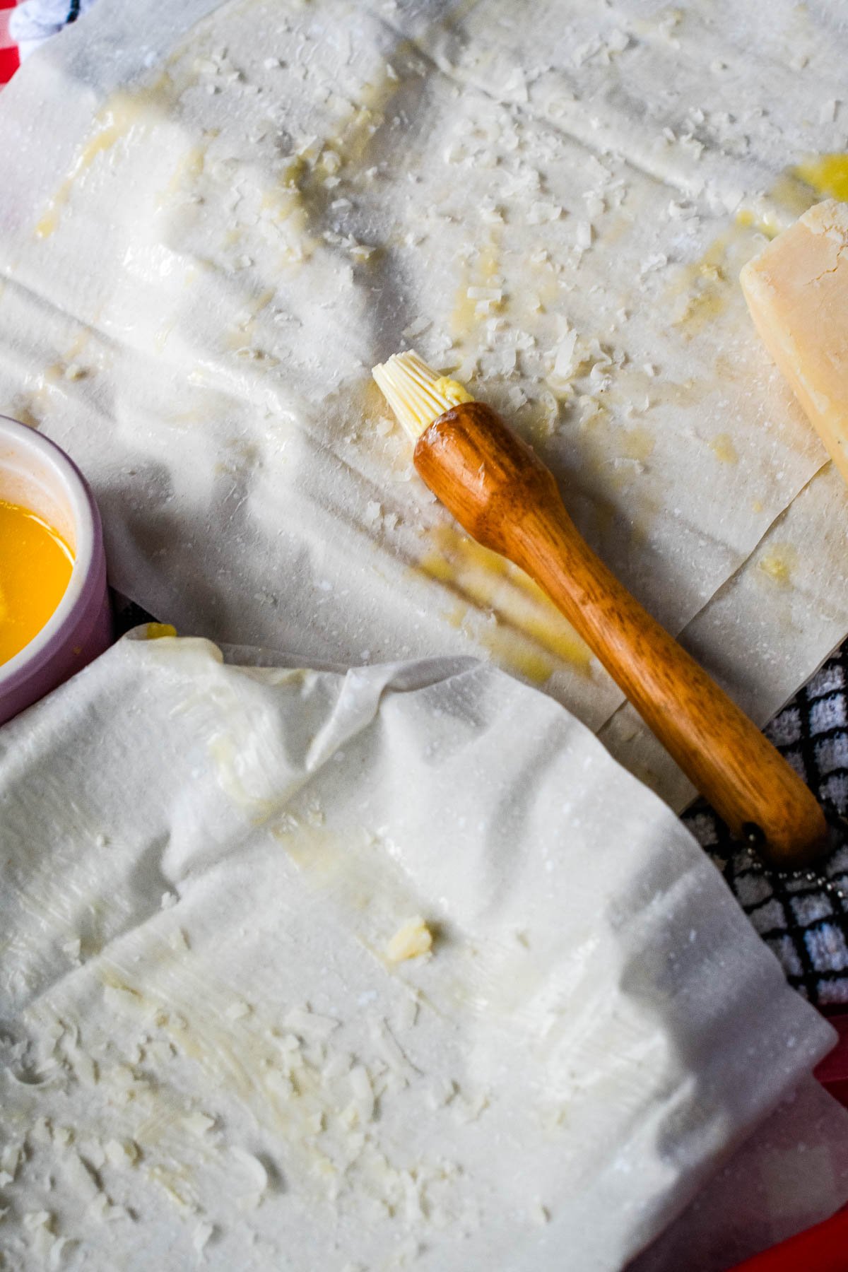preparing filo pastry with butter on a brush