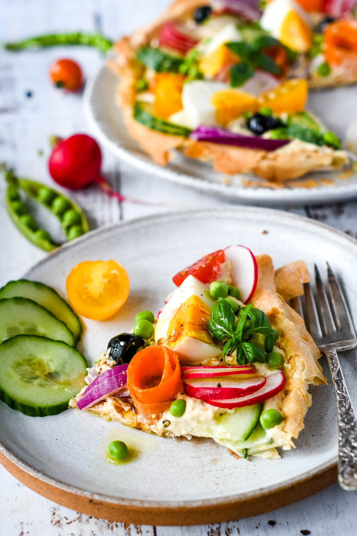 single silce of vegetable filo tart with remaining tart behind