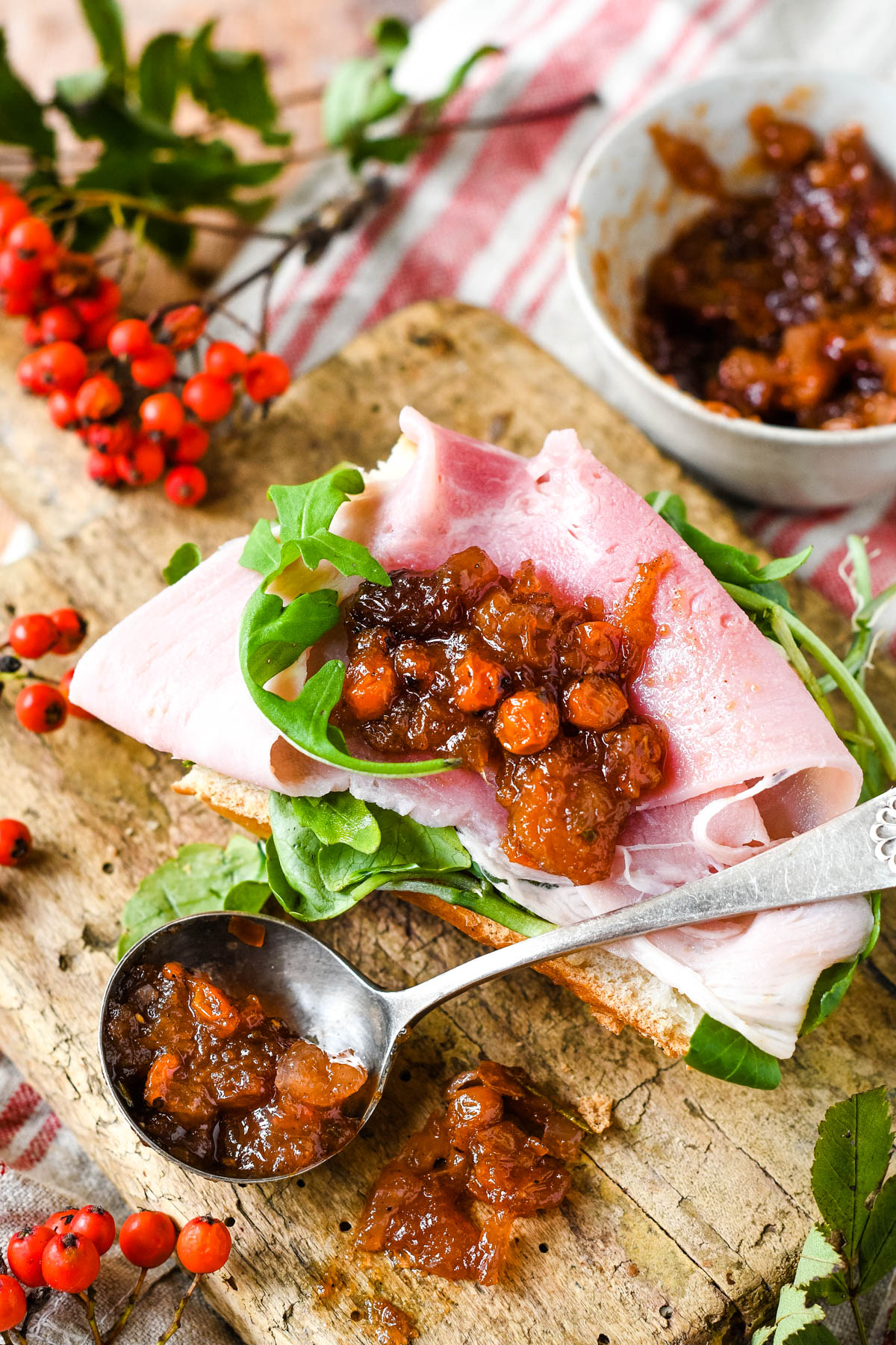 chutney on spoon with bread and ham and salad