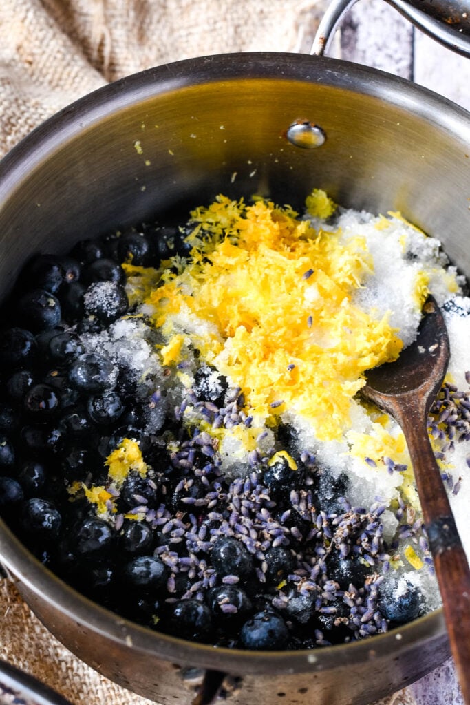 all ingredients in pan with wooden spoon