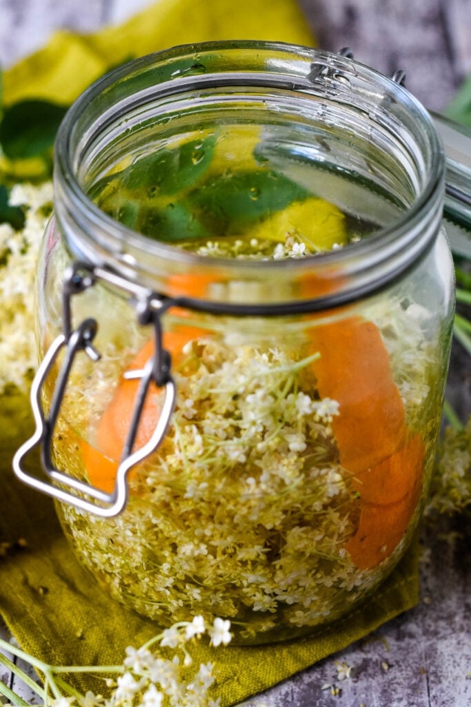 vinegar added to the jar with the elderflowers and orange zest