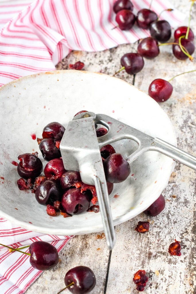 stoning the cherries on plate