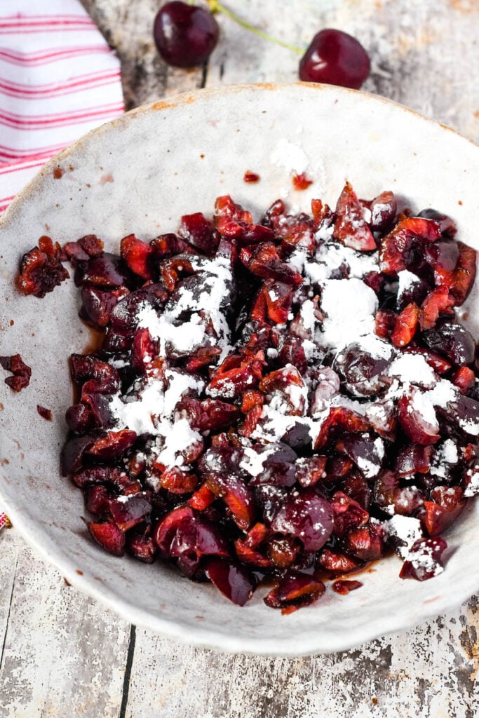 cherries in a bowl with icing sugar