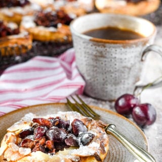 cherry puff tarts alonside cup of coffee