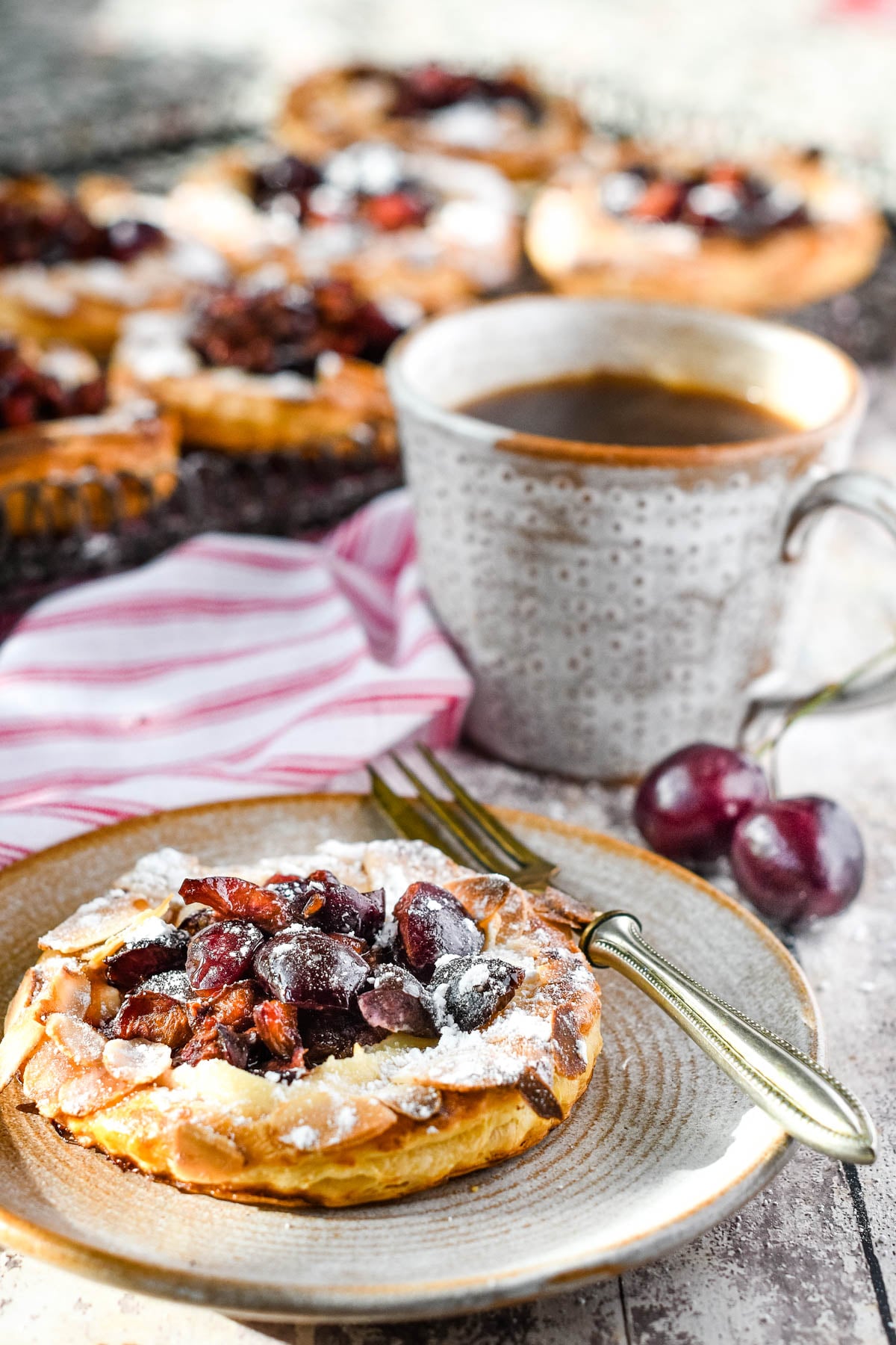cherry puff tarts alonside cup of coffee
