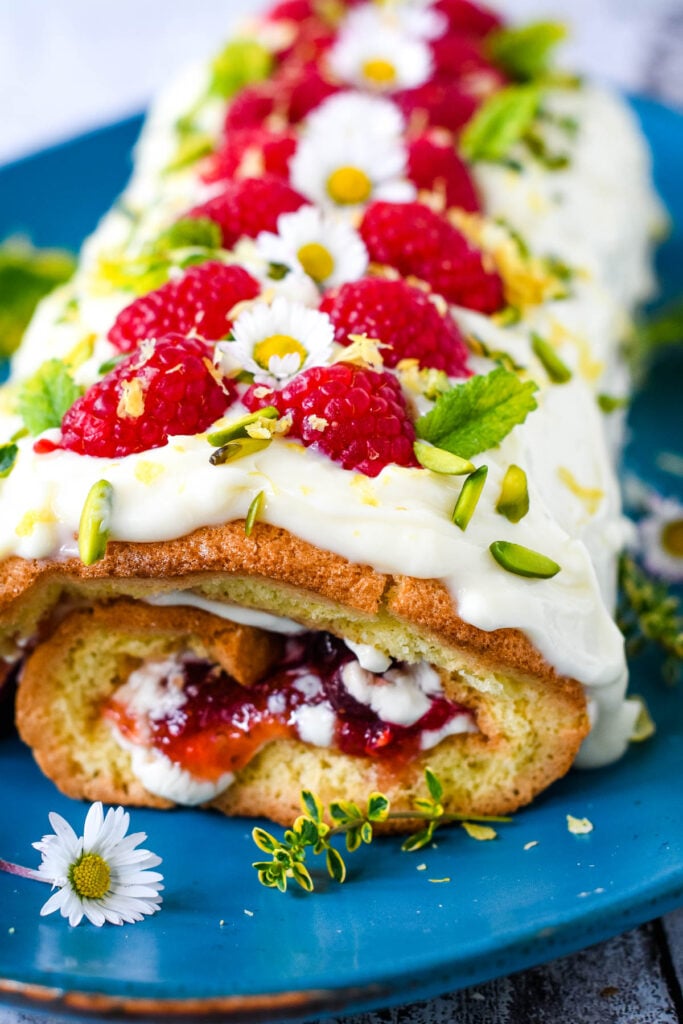 finished raspberry and lemon roulade on blue plate