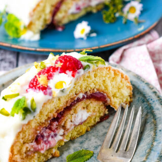 raspberry and lemon roulade on plate with berries