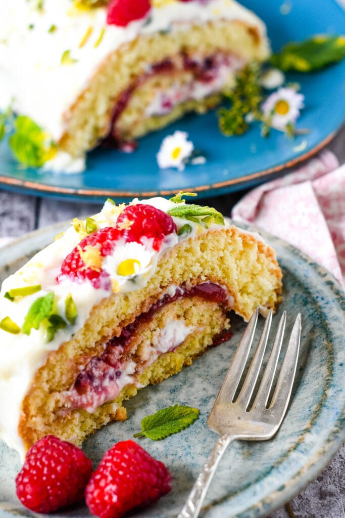 raspberry and lemon roulade on plate with berries