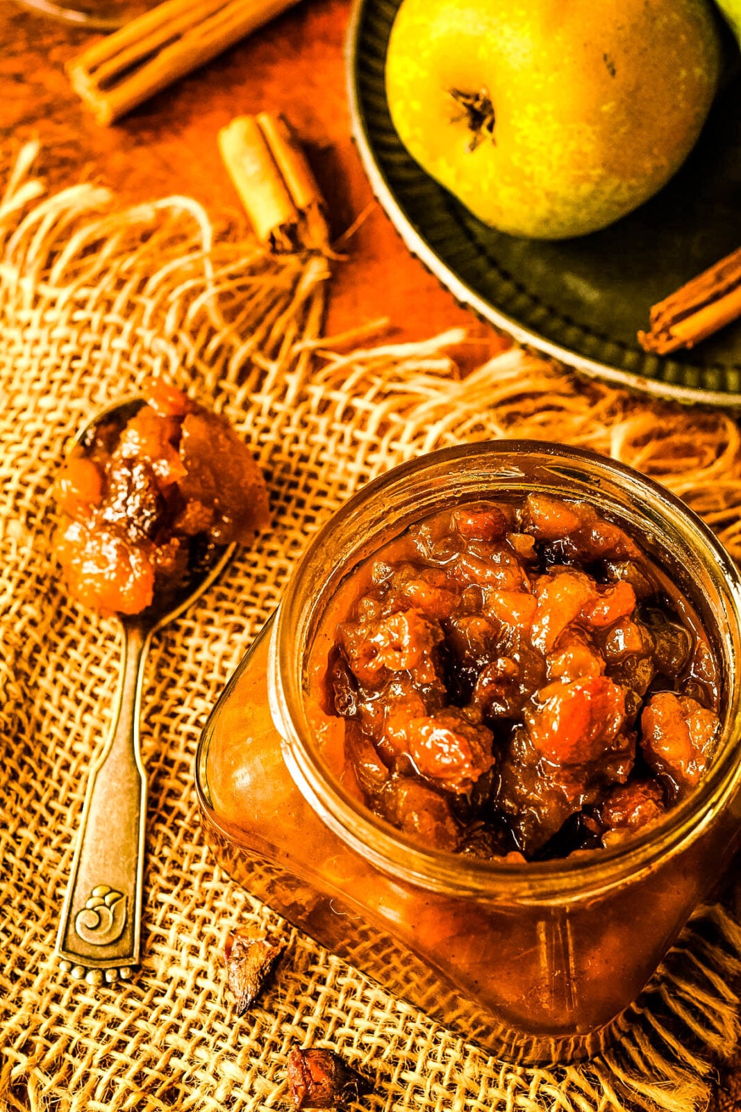 pear chutney in jar with spoon beside